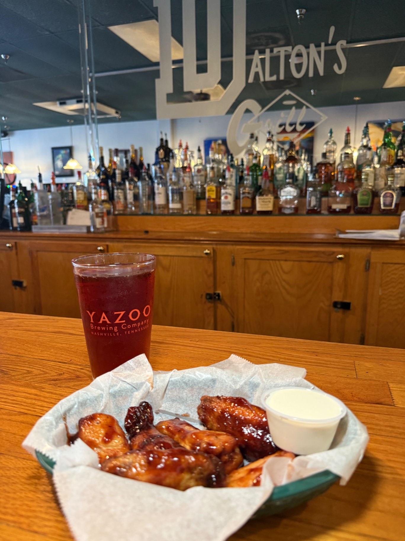BBQ wings and a Yazoo draft beer at the bar inside Dalton's Grill